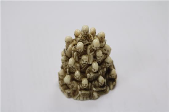 A Japanese ivory netsuke of multiple rakan, Meiji period, height 5.6cm